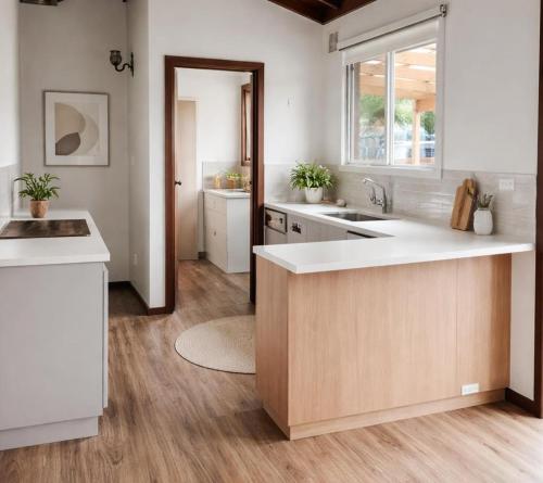 a kitchen with a sink and a counter top at Barnard Beach House in Broadwater
