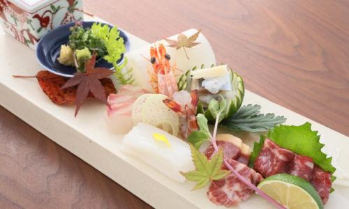 a plate of food on top of a table at Gekkoju Kurokawa in Minamioguni