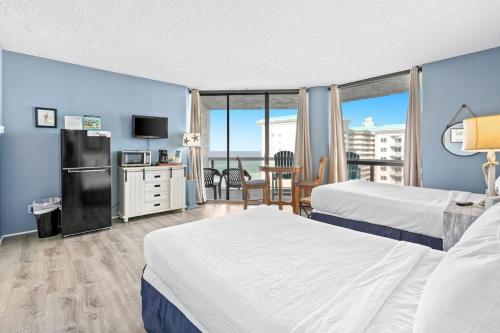 a hotel room with two beds and a balcony at Gorgeous and well appointed efficiency with shared pool and beach access in Destin