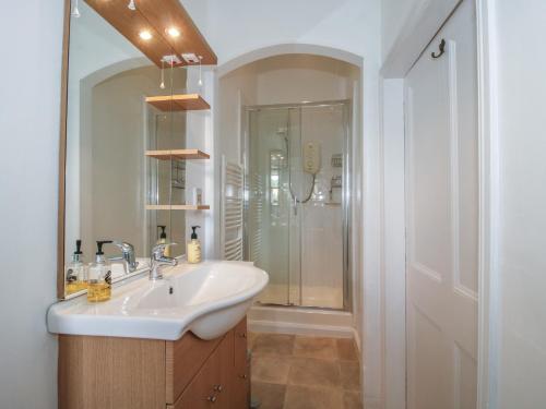 a bathroom with a sink and a shower at The Old Nursery in Much Wenlock