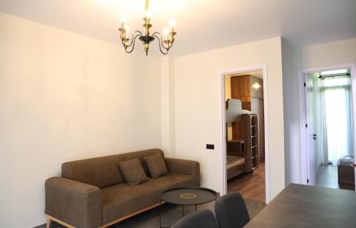 a living room with a couch and a table at Newly Renovated 10 Min To Center in Gomi