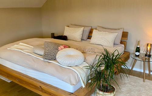 a large bed with pillows on it in a room at Simply Enjoy Ferienwohnungen in Losheim