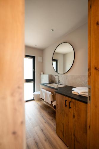a bathroom with a sink and a mirror at Adler Apartments in Bach