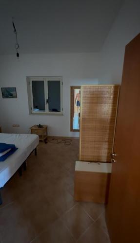 a room with a bed and a mirror in it at Residenze Poseidon in Le Castella