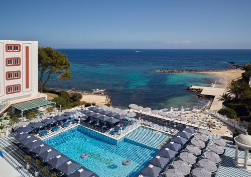 an aerial view of a resort with a swimming pool and the ocean at Hotel Mongibello Ibiza in Santa Eularia des Riu