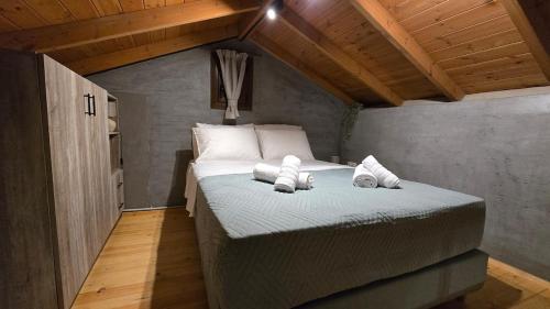 a bedroom with a bed with two towels on it at Stay In Zia in Asfendioú