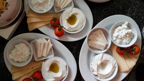 a table with plates of food with eggs and cheese at Betzel Ha'Ella in Kahal