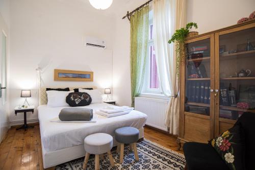 a bedroom with a large bed with two stools at Thalgiron, a breath away from Delphi in Ámfissa