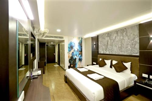 a bedroom with a large bed in a room at HOTEL RUBY PALACE in Tiruchirappalli