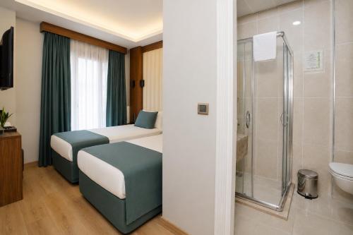 a small bathroom with a bed and a shower at Hotel Black Tulip in Istanbul