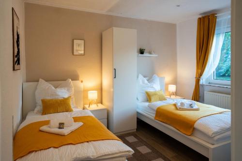 a bedroom with two beds with towels on them at Shaft by Loftigo - Apartment mit Wellnessdusche in Übach-Palenberg