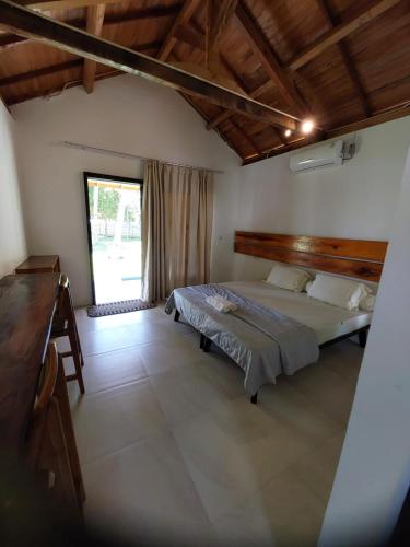 a bedroom with a bed and a large window at Slab Krui Bungalows in Krui