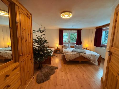 a room with two beds and a christmas tree in it at Naturhof Kluge in Saupsdorf