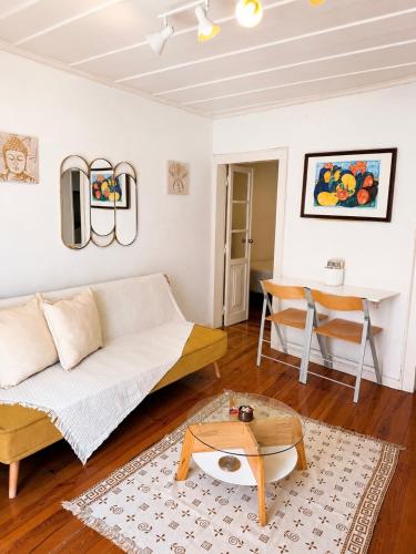 a living room with a couch and a table at Central Lisbon Apartment Santos Walk to Cais do Sodré in Lisbon