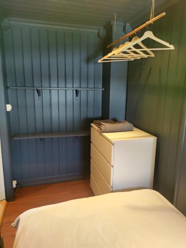 a room with a refrigerator and a bed in it at Et soverom, delt bad in Fredrikstad