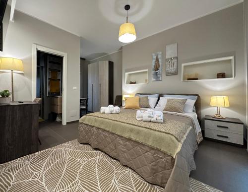 a bedroom with a large bed with two towels on it at Agorà Connect Space in Brindisi