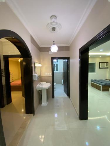 a room with a bathroom with a sink and a bed at كازا in Taif