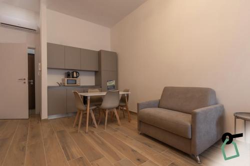 a living room with a chair and a table at Collegno Cozy Apartments in Turin