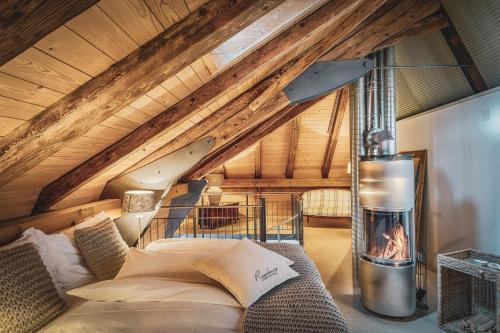 a room with a bed and a fireplace at Romantik Hotel Bären Dürrenroth in Dürrenroth