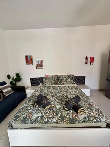 a large bed in a bedroom with a large bedspread at Private Room and Own Kitchen Steps to Beach & Nightlife in Sliema
