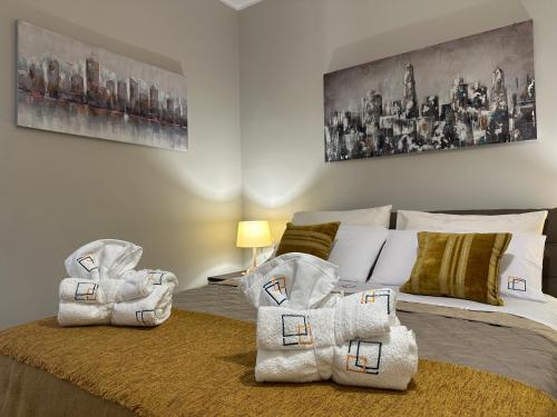 a bedroom with a bed with towels on it at Agorà Connect Space in Brindisi