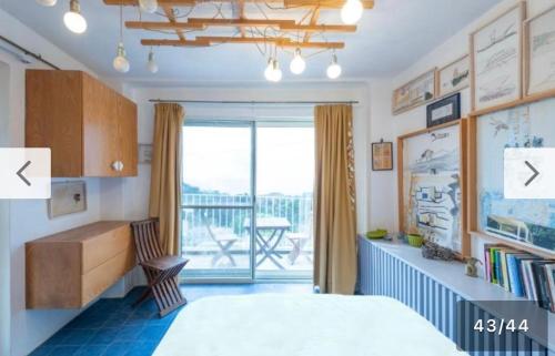a bedroom with a bed and a desk and a balcony at Casa Tiberius Capri Retreat by Sweet Capri in Capri