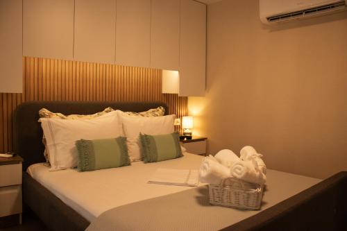 a hotel room with a bed with towels on it at Chryso Boutique Guesthouse in Chrysoupolis