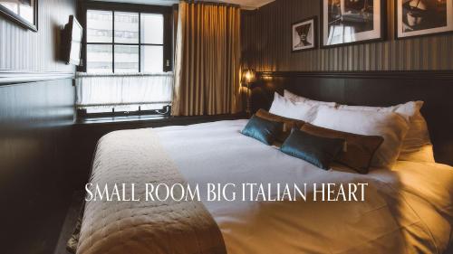 a large bedroom with a large bed with pillows at Hotel & Ristorante Bellora in Gothenburg