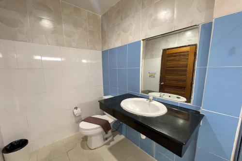 a bathroom with a sink and a toilet and a mirror at Fairtex Residence Pattaya in North Pattaya