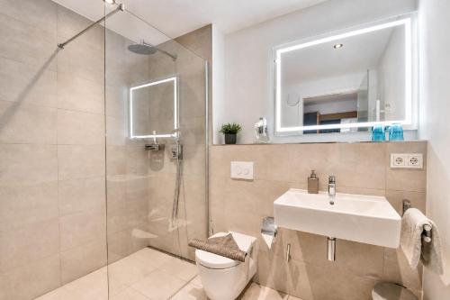 a bathroom with a toilet and a sink and a shower at Ferienwohnung Grünfink 04 im Wreecher Idyll Rügen by ruyastay in Putbus