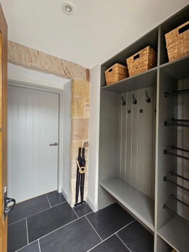 a walk in closet with a man figure on the wall at Balnain Street Cottage in Inverness