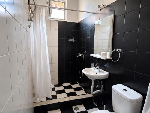 a black and white bathroom with a toilet and a sink at Bella Casa Lydia - Peaceful Retreat in Rhodes in Rhodes Town
