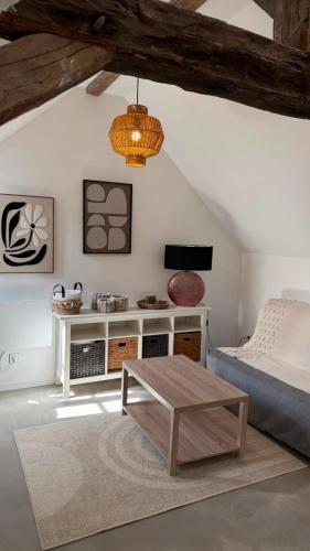 a bedroom with a bed and a coffee table at Le Cœur de Saint-Aignan in Saint-Aignan