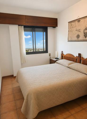 a bedroom with a large bed and a window at Ca La Morancica in Yátova