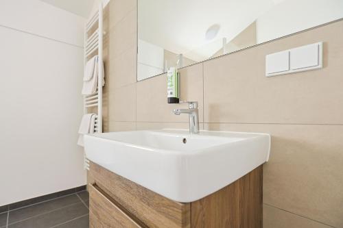 a bathroom with a white sink and a mirror at Kaffeegarten Am Mühlwerder in Halle an der Saale