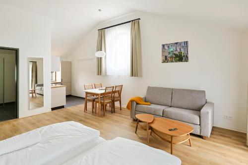a living room with a couch and a table at Kaffeegarten Am Mühlwerder in Halle an der Saale