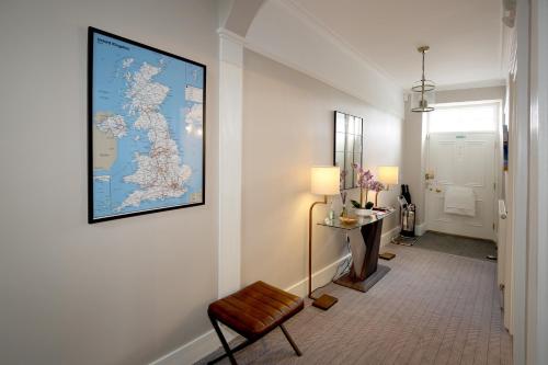 a hallway with a chair and a picture on the wall at No. 41 Town House in Inverness