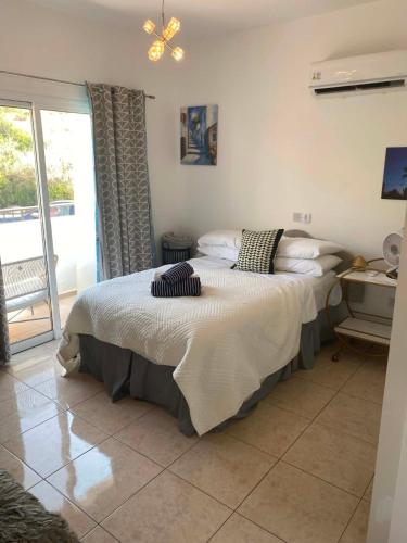 a bedroom with a large bed with pillows on it at ATLANTIS Penthouse Apartment with Jacuzzi plus Pool and Sea Views in Peyia