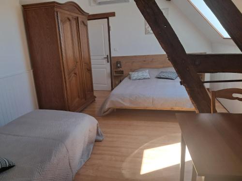 a bedroom with a bed and a dresser in a room at La Sénonaise in Sens sur Seille