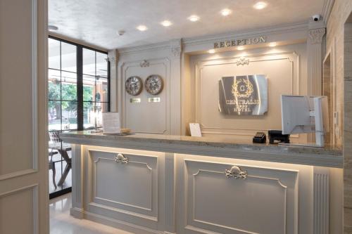 a reception area of a hotel with clocks on the wall at Centralis Hotel in Haskovo