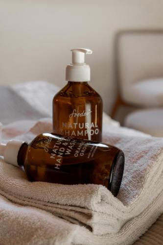 a bottle of moisturizing hand soap sitting on a towel at Casa Prana in Tegna