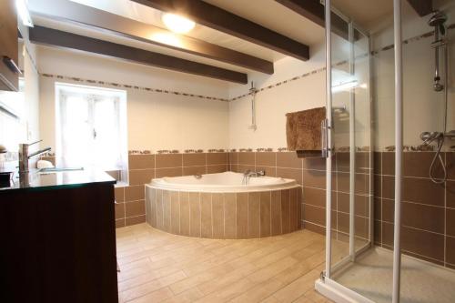 a large bathroom with a tub and a shower at Sagarra in Saint-Étienne-de-Baïgorry