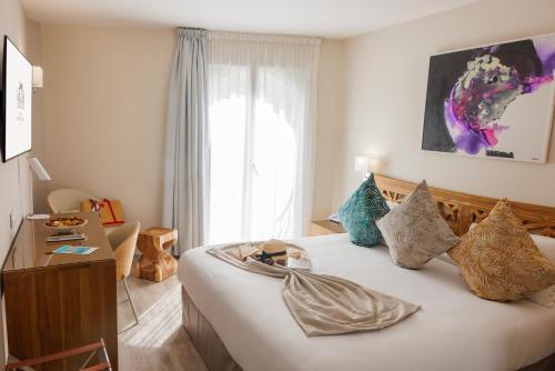 a hotel room with a bed and a window at Cristal Hôtel & Spa in Cannes