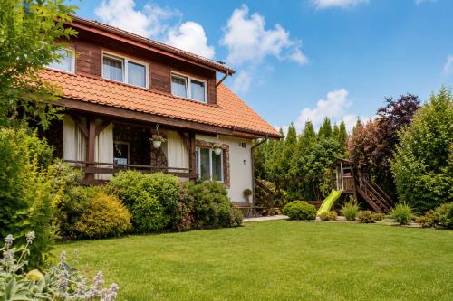 a house with a yard with a slide at Rodzinny zakątek "U Głuszków" Bieszczady in Myczkowce
