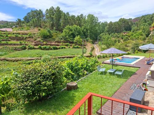 a view of a garden with a swimming pool at Quinta da Peça Douro Wine Region Retreat, Private Pool Villa in Vila Real