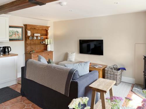 a living room with a couch and a tv at The Cartshed - Uk50426 in Malton