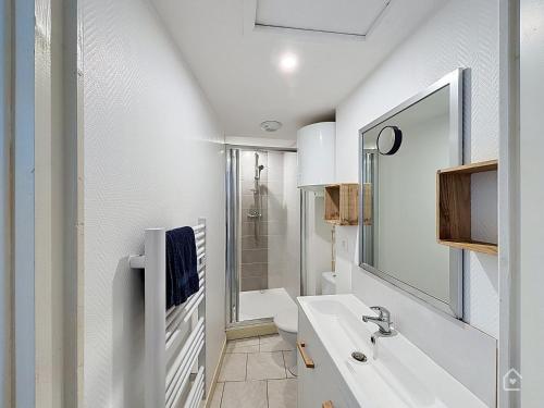 a white bathroom with a sink and a shower at Urban Grey - Terrasse - Wifi in Châtellerault