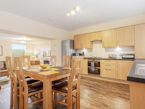 a large kitchen with a wooden table and chairs at The Knott - Uk49161 in Silverdale