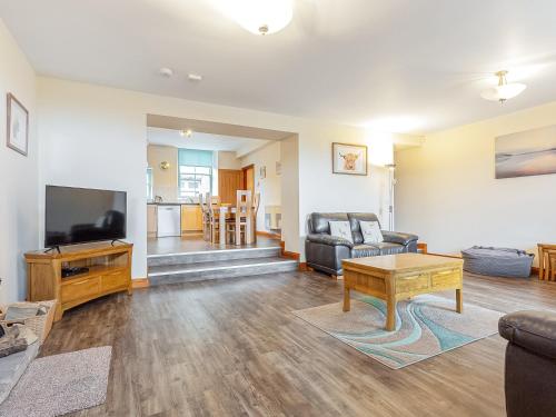 a living room with a couch and a tv at The Knott - Uk49161 in Silverdale