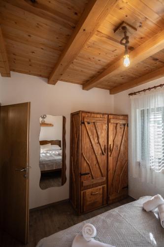 a bedroom with a bed and a wooden ceiling at Villa MaLea in Neum
